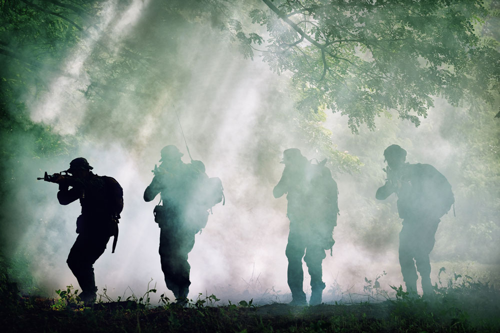 4 Silhouette troops walking in foggy forest