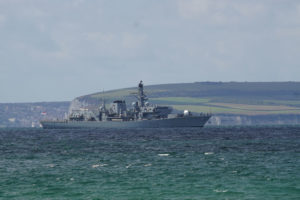 Battleship in the sea with farmlands in background