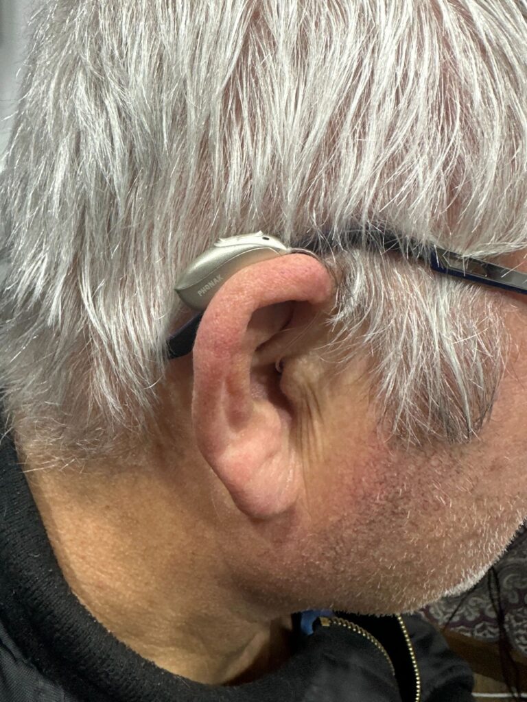 Mr Inott equipped with hearing aids